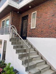 a staircase leading to a brick building with a door at Stay In Itaewon in Seoul