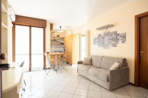 a living room with a couch and a kitchen at Bologna - The Suite Apartment in Bologna +23 photos