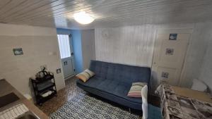 a living room with a blue couch in a room at Guesthouse Pijerino in Valun