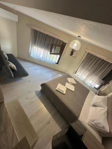 a bedroom with a bed with two towels on it at Lajes Apartment in Skala Potamias