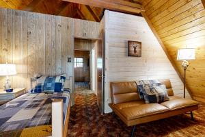 a bedroom with a couch and a bed in a room at The Kachina Cabin in Mountainaire