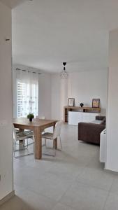 a living room with a table and a couch at FlyDream - Salerno Costa d'Amalfi Airport in Salerno Airport - Aeroporto di Salerno