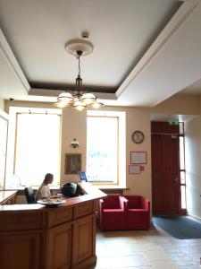 a woman sitting at a desk in a room at Alexa Old Town in Vilnius