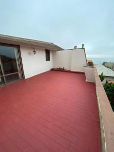a house with a red floor and a patio at CasaOcho2 in Viña del Mar +9 photos