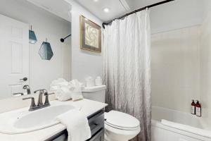a white bathroom with a sink and a toilet at Sunny Palm Springs Oasis Getaway in Palm Springs +16 photos