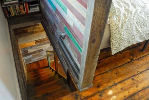 a stairway leading up to a bedroom with a bed at Secluded Couples Retreat on Farm in Paonia! in Paonia