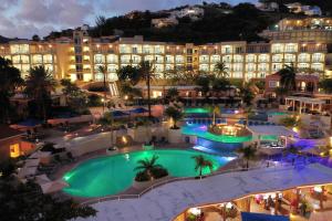 an aerial view of a hotel with a pool at night at Divi Little Bay Beach Resort in Philipsburg