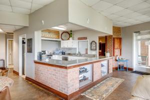 a large kitchen with a counter in a room at 1 Mi to Lake Guntersville Scenic Condo Retreat! in Scottsboro
