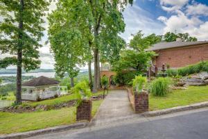 a brick house with a garden and a driveway at 1 Mi to Lake Guntersville Scenic Condo Retreat! in Scottsboro