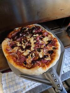 a pizza sitting on top of a metal pan at Landcafe Kauder in Stadl an der Mur