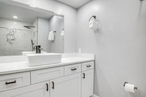 a white bathroom with a sink and a mirror at Fishing Paradise Lake Poinsett Home with Deck! in Cocoa +22 photos