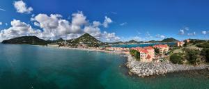 an aerial view of a beach with buildings and the water at Divi Little Bay Beach Resort in Philipsburg
