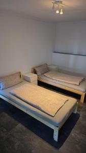 two beds sitting in a room at Sweet Ferien & Monteurs Appartement in Wuppertal