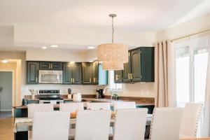a kitchen with green cabinets and a table and chairs at The Estate on 68 AND Pet Friendly in Springfield +77 photos