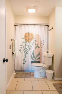 a bathroom with a toilet and a shower curtain at The Estate on 68 AND Pet Friendly in Springfield