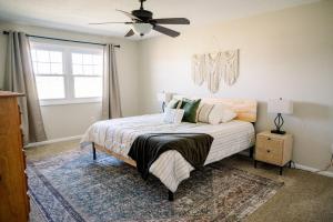 a bedroom with a bed and a ceiling fan at The Estate on 68 AND Pet Friendly in Springfield