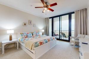 a bedroom with a bed and a ceiling fan at Holiday Isle 618 in Dauphin Island +26 photos