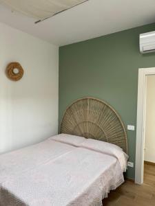 a bedroom with a large bed with a white blanket at Oasibellavista in Cavo