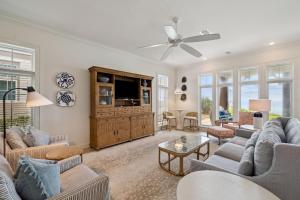 a living room with couches and a tv at Always On My Mind by 30A Escapes in Seacrest