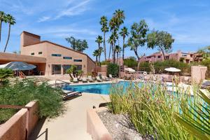 a pool at a resort with chairs and umbrellas at Mtn-View Condo w/ Resort Amenities in Tucson! in Tucson
