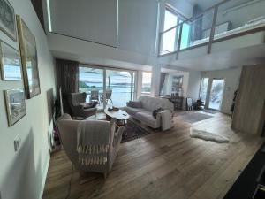 a living room with a couch and a table at Seaside Panorama Villa in Gothenburg