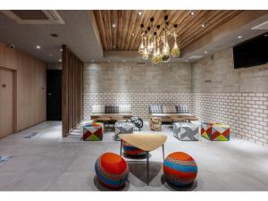 a lobby with tables and chairs and a chandelier at Smile Hotel Okayama - Vacation STAY 60155v in Okayama