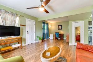 a living room with a couch and a tv at Downtown Coeur dAlene Home - Walk to Lakefront! in Coeur d'Alene