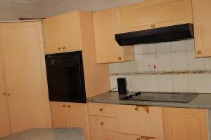 a kitchen with a black refrigerator and a sink at Broadhurst Homestay in Gaborone