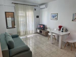 un soggiorno con un divano e un tavolo di 3 Bedroom House, 200m from Trikorfo Beach a Yerakiní