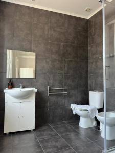 a bathroom with a toilet and a sink at Menina da Ria Guest House in Aveiro