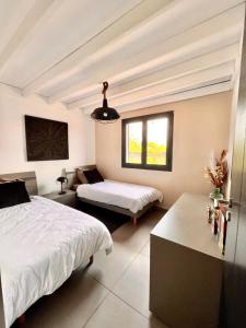 a bedroom with two beds and a couch and a window at La Villa LIFE in La Plaine des Palmistes +9 photos