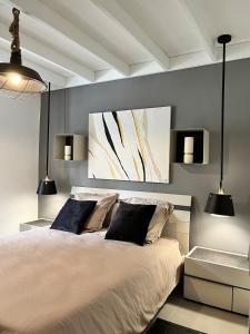 a bedroom with a large bed with two pillows at La Villa LIFE in La Plaine des Palmistes
