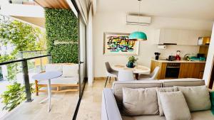 a living room with a couch and a table at Ipana Luxury Suites By Caribe Rentas in Playa del Carmen