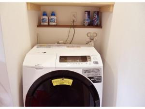 a washer and dryer in a corner of a room at Hotel Hanafuji Inn - Vacation STAY 82519v in Nakafurano