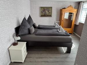 a bed with pillows on it in a bedroom at Himmel & Hölle Pölkenstraße in Quedlinburg