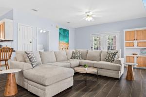 a living room with a couch and a table at Sunkissed and Salty by Newman-Dailey in Destin +41 photos
