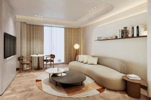 uma sala de estar com um sofá e uma mesa em The Landmark Nicosia, Autograph Collection em Nicósia