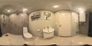 a bathroom with a white toilet and a sink at Atlanterhavsveien Rorbuer in Averoy +163 photos