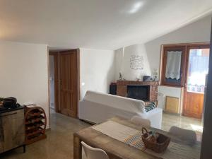 a living room with a couch and a fireplace at Attico da Luisa in Camigliatello Silano