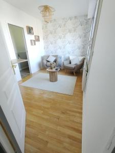 a living room with a couch and a table at Val de la Lacquette in Enquin-les-Mines