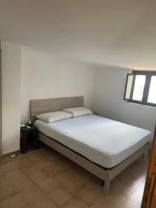 a bed with two pillows on it in a room at Attico da Luisa in Camigliatello Silano