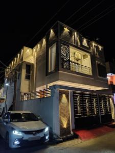 a car parked in front of a building at night at THE VILLA Pondicherry in Puducherry