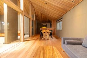 a living room with a couch and a table at Shiraho Villa Square Court - Vacation STAY 63025v in Shiraho