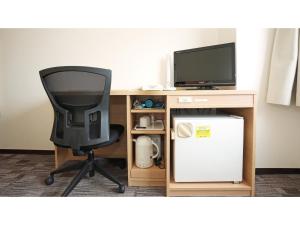 a desk with a chair and a computer monitor at Smile Hotel Kumagaya - Vacation STAY 64099v in Kumagaya +25 photos