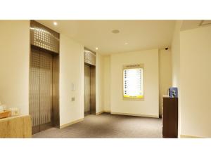 a hallway with two doors and a window at Smile Hotel Kumagaya - Vacation STAY 64099v in Kumagaya