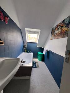 a bathroom with a white tub and a sink at Vue mer exceptionnelle-Appartement cosy à Erquy in Erquy +17 photos