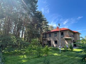 an old stone house with a red roof at 4 winds Zephyrus in Palanga