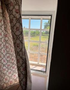 a window in a room with a curtain at Vendrisine lacco rosso 1436 in Casarano