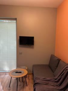 a living room with a couch and a table at 4 winds Zephyrus in Palanga