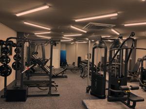 a gym with several treadmills and cardio machines at Silver Heights 3rd floor 302,303,304 - Vacation STAY 65741v in Osaka